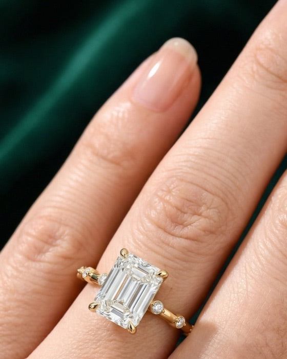 Lyra emerald engagement ring on the hand