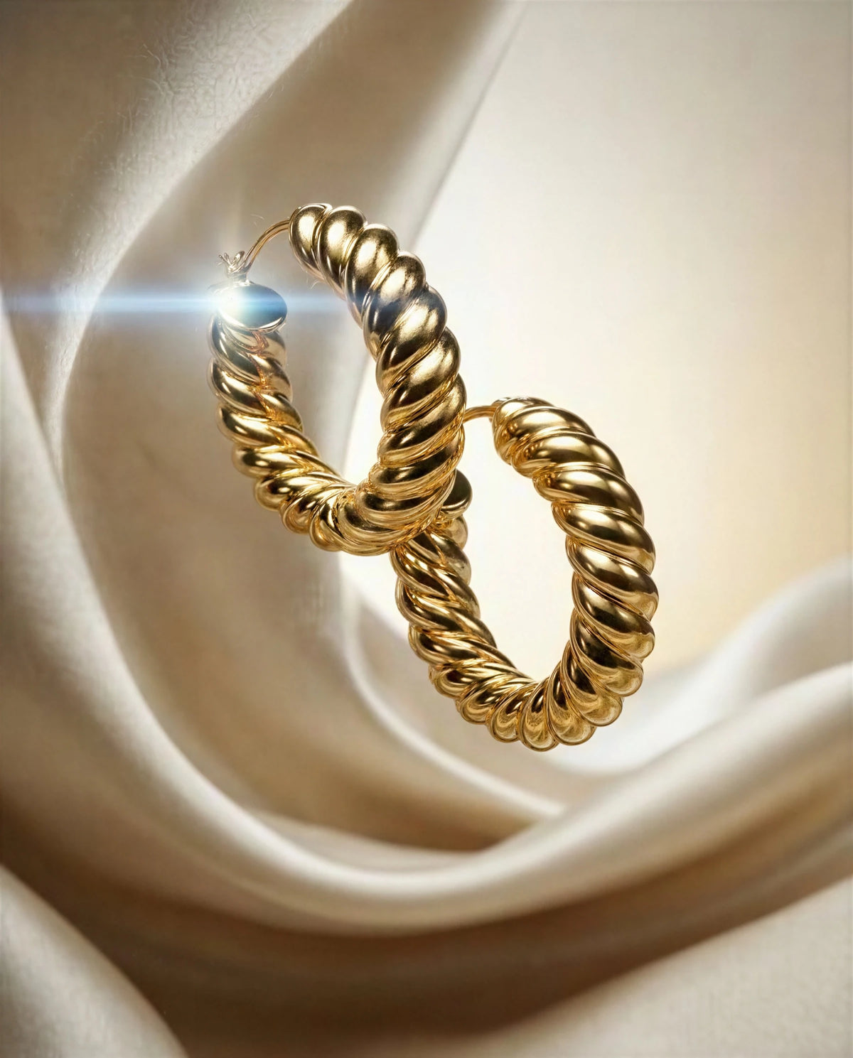 Marigold 14k gold ribbed croissant hoops on ivory satin, another angle