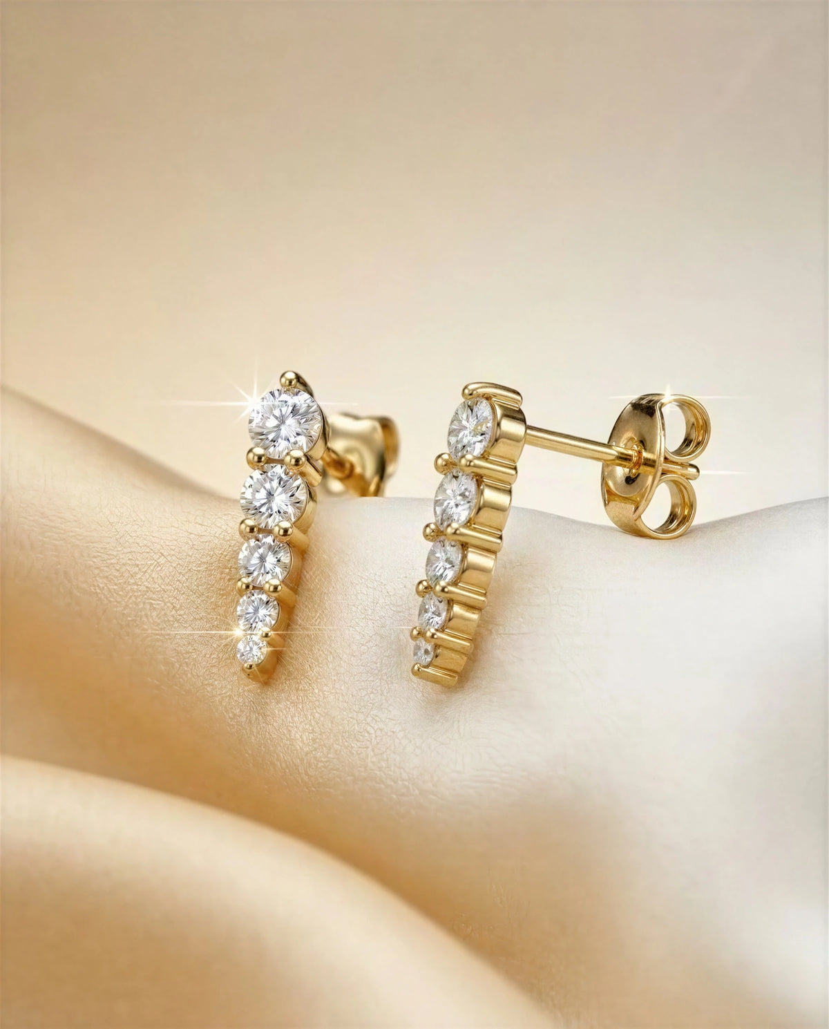 Stephanotis 14k gold graduated studs on ivory satin