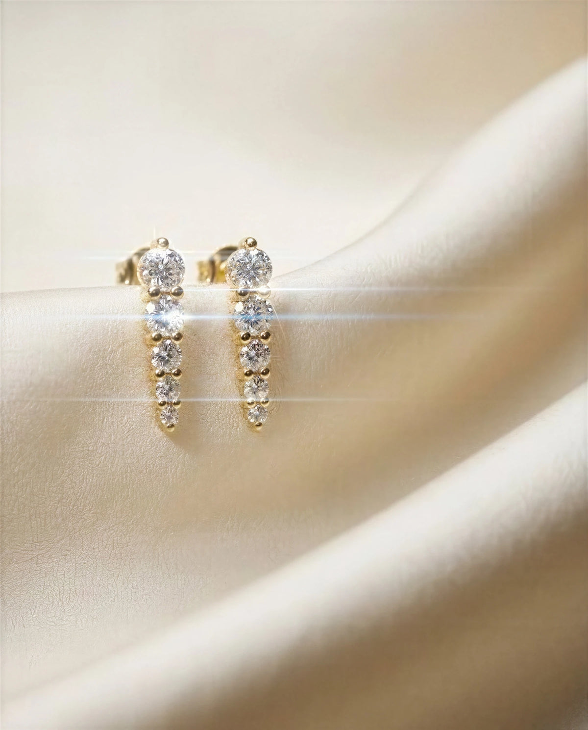 Stephanotis 14k gold graduated studs on ivory satin, another angle