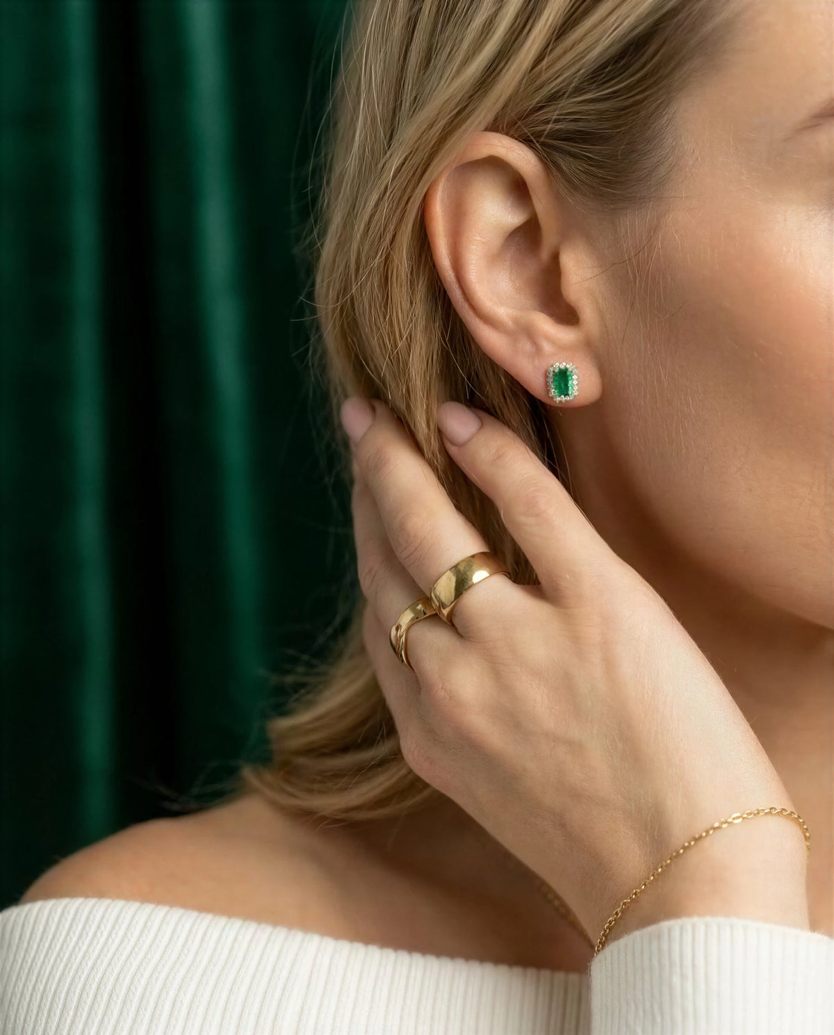 Cymbidium 14k gold emerald halo studs worn on the ear, another view