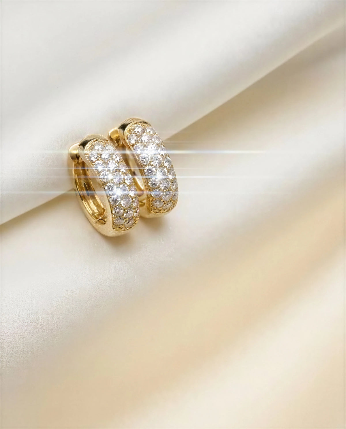 Alyssum 14k gold pavé huggies on ivory satin, another angle