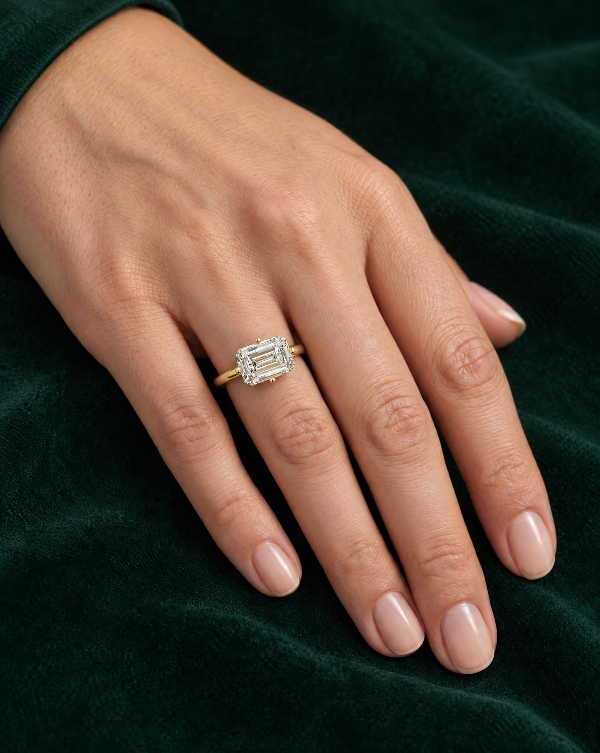 Elowen emerald engagement ring worn on the hand
