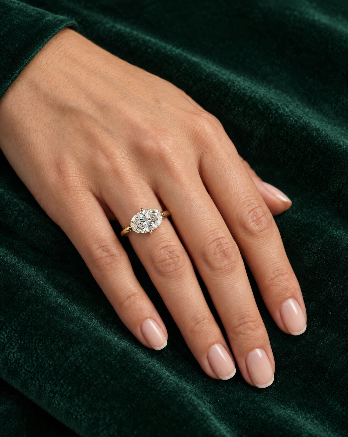 Elowen oval engagement ring worn on the hand