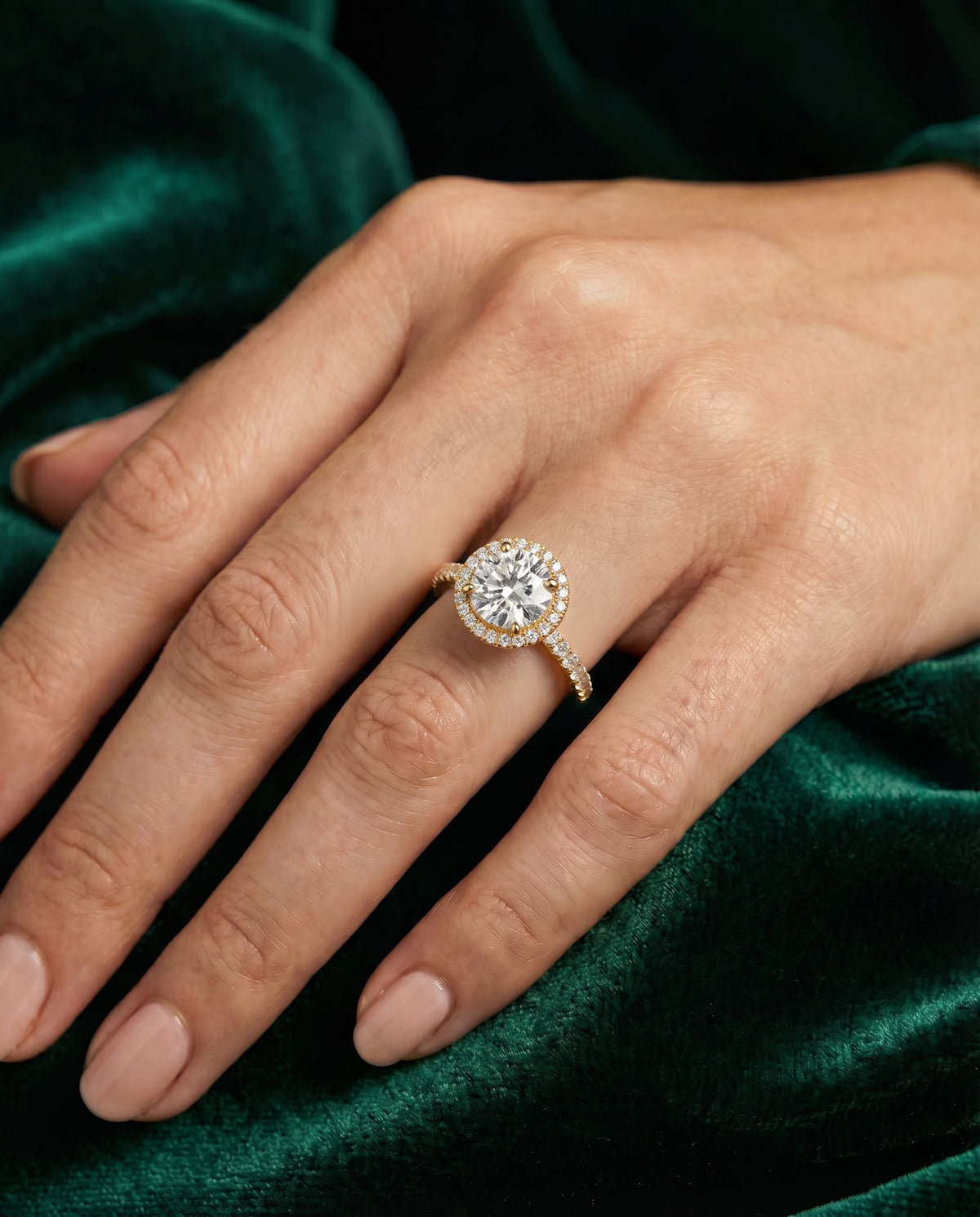 Elysian round engagement ring worn on the hand