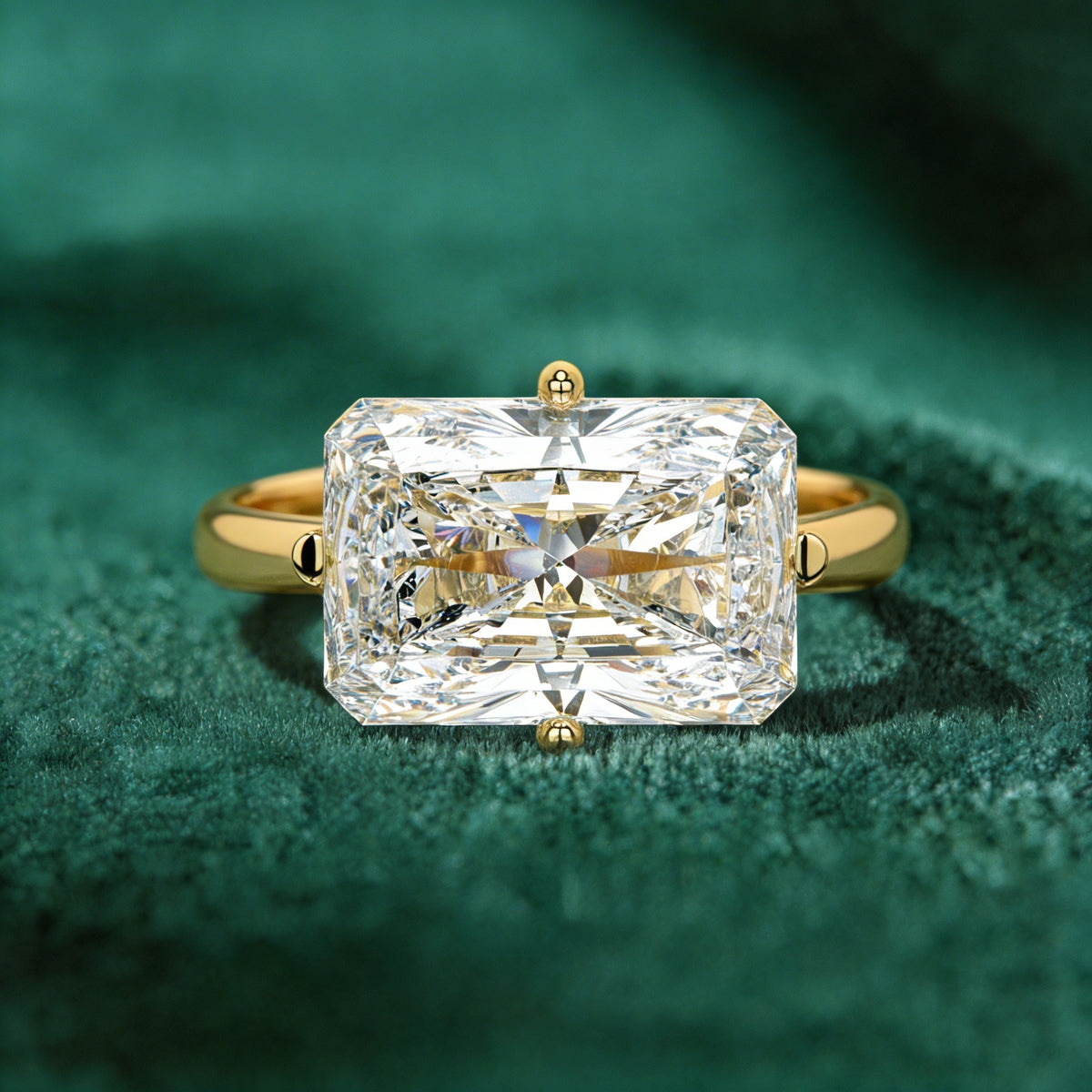 Elowen radiant engagement ring in yellow gold on green velvet