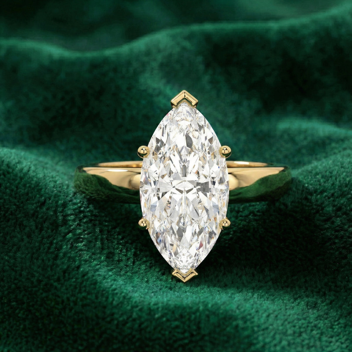 Luna marquise solitaire engagement ring in yellow gold on green velvet