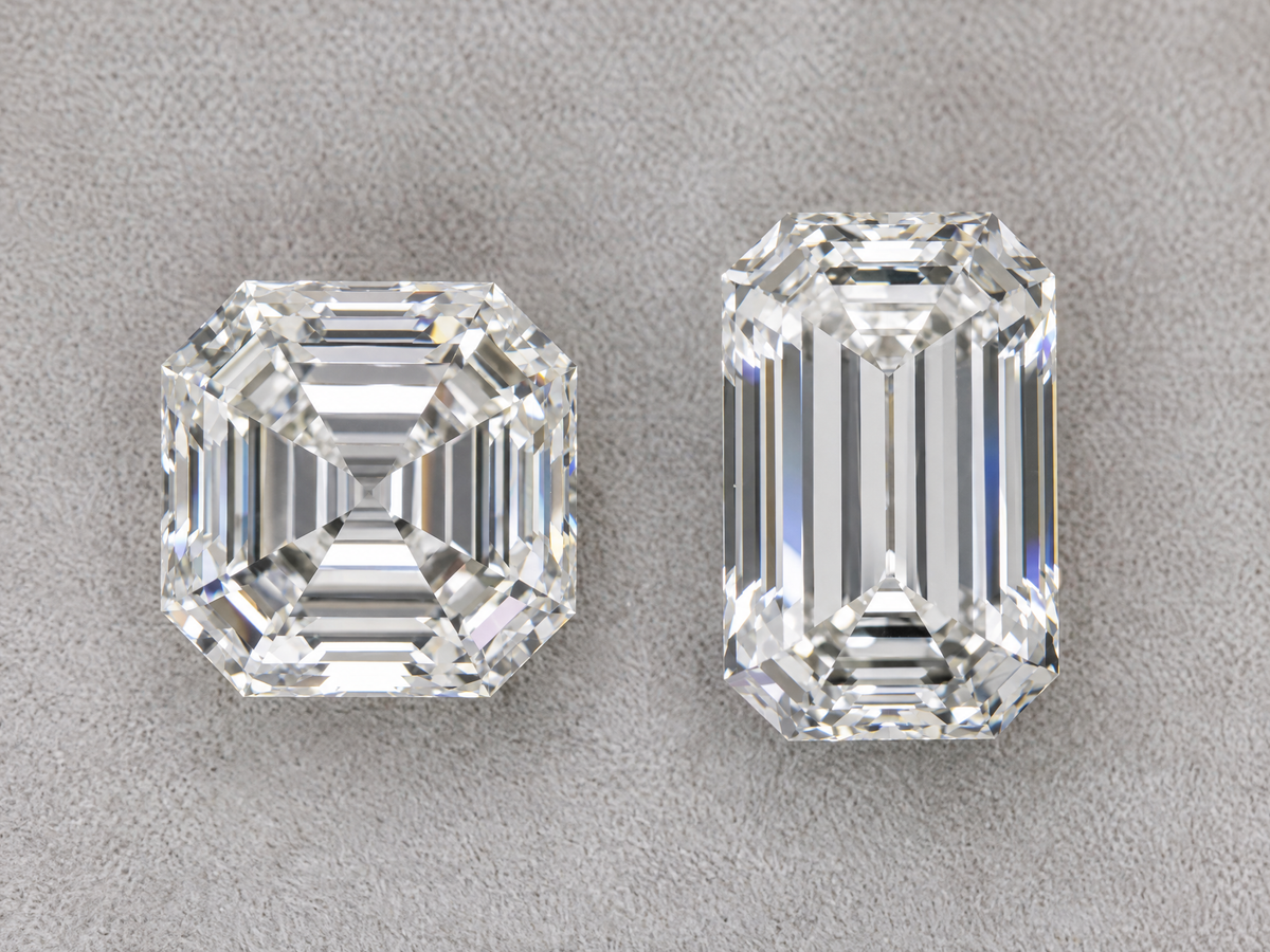 An Asscher cut diamond and an emerald cut diamond of the same carat weight side by side, face up