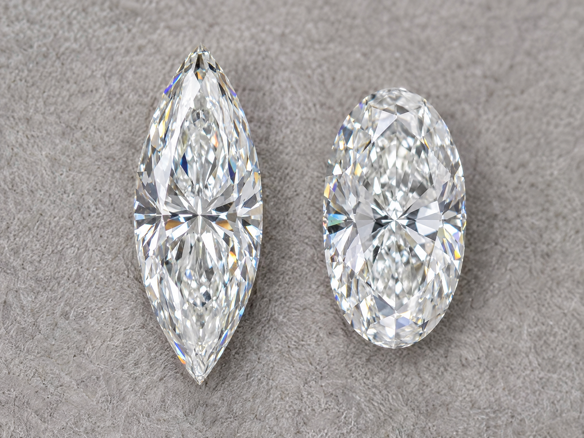 A marquise diamond and an oval diamond of the same carat weight side by side, face up