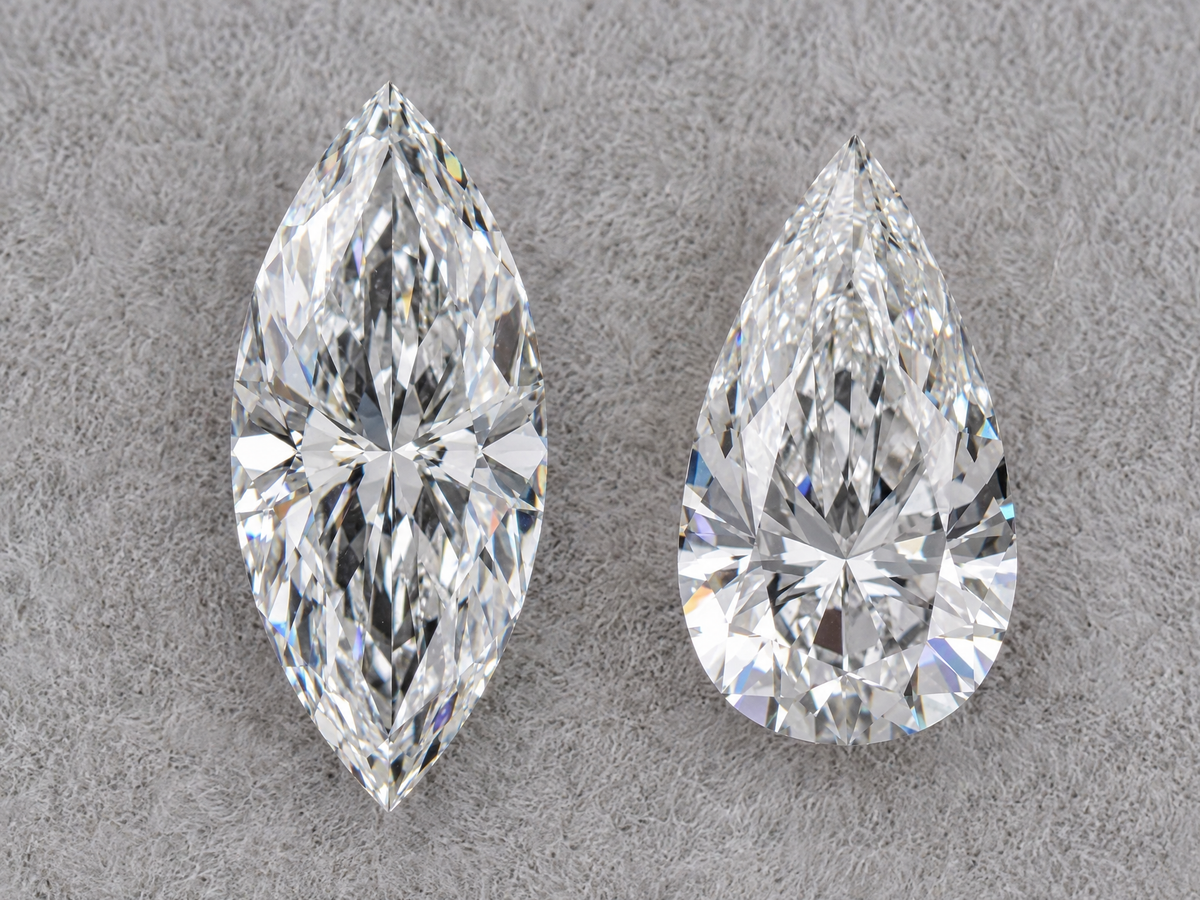 A marquise diamond and a pear shaped diamond of the same carat weight side by side, face up