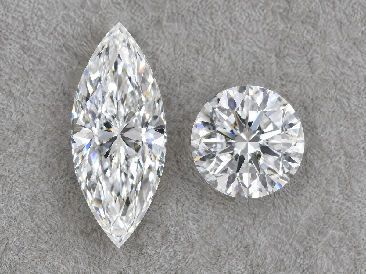 A marquise diamond and a round diamond of the same carat weight side by side, face up