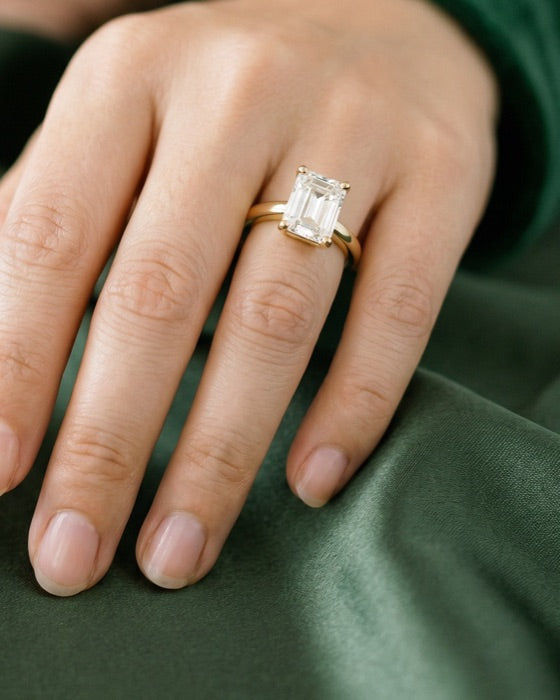 Verona emerald engagement ring on the hand